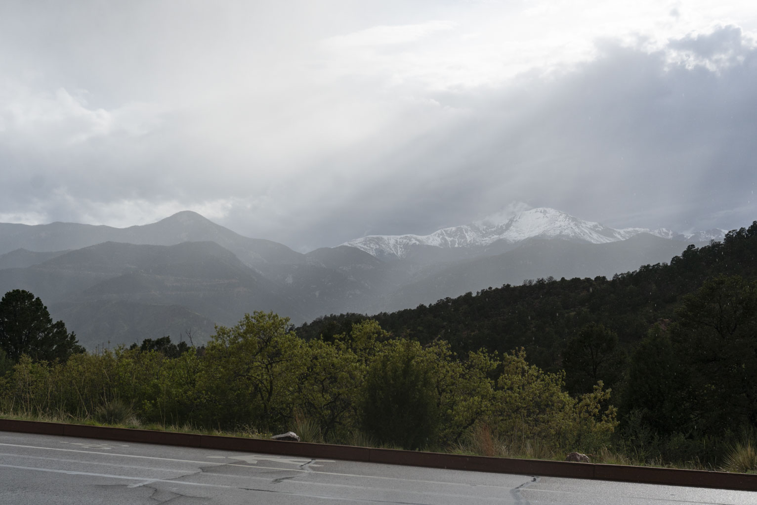 Rain mostly passed over mountains, dramatic clouds, rays of light, raindrops falling